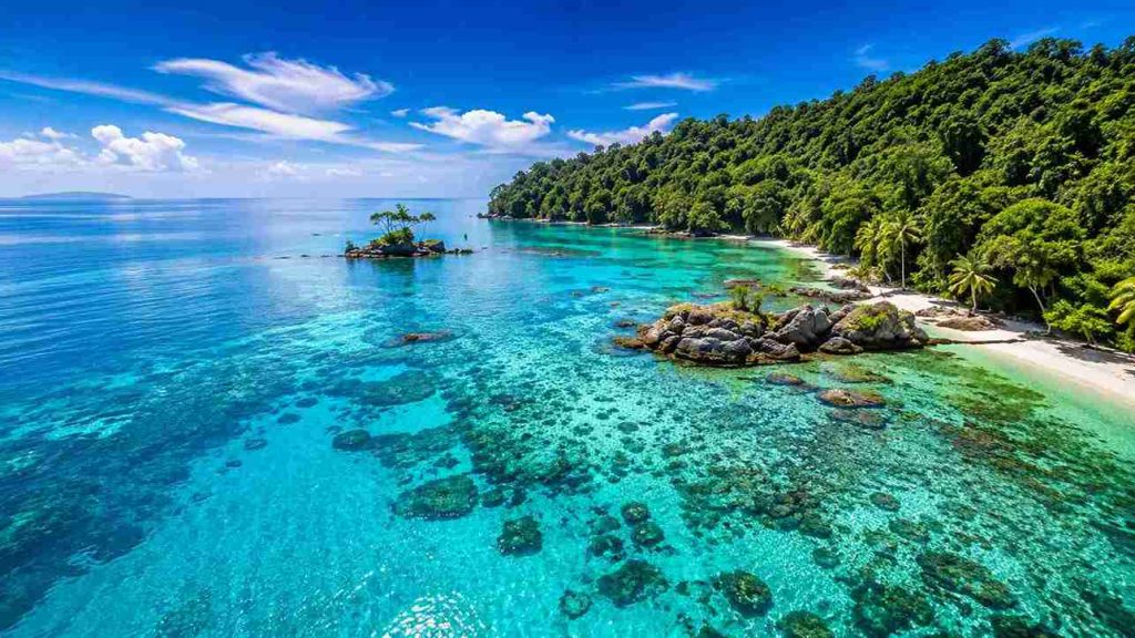 Aerial view of Bunaken Marine Park with crystal-clear turquoise waters, coral reefs, tropical coastline, and lush rainforest in North Sulawesi, Indonesia | Komera.net